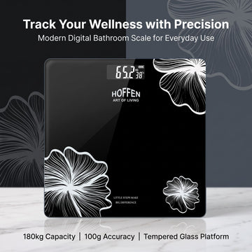 Hoffen black digital bathroom scale with white floral design, 180kg capacity and tempered glass platform.